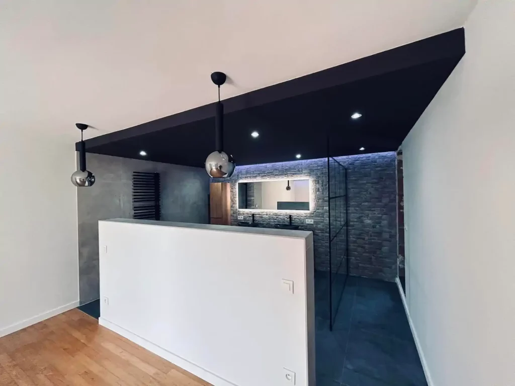 Salle de bain contemporaine rénovée à Baelen avec muret de séparation, verrière et plafond sombre